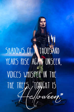 bride in black dress and veil holding rose and candles near poem on blue with smoke