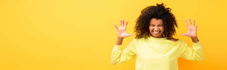 angry african american woman in sweatshirt on yellow, banner