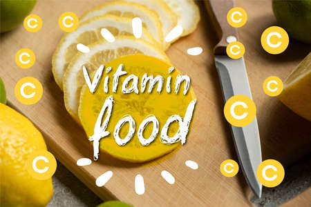 close up view of sliced lemon on wooden cutting board with knife, vitamin food illustrationの写真素材