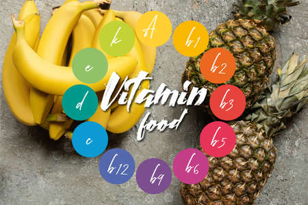 top view of colorful delicious bananas and pineapples on gray concrete surface, vitamin food illustrationの写真素材