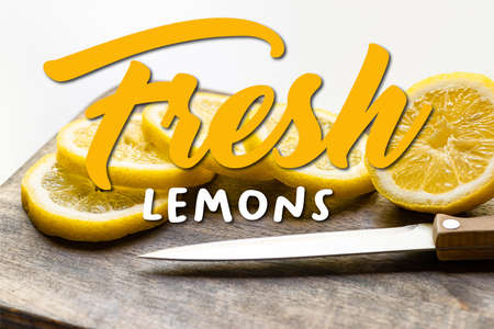 selective focus of hot lemon on wooden cutting board with knife on white background, fresh lemons...