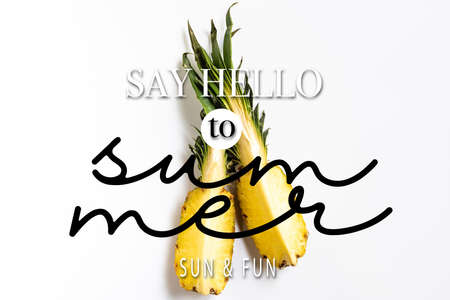 top view of cut ripe pineapple with green leaves on white background with say hello to summer illustrationの写真素材