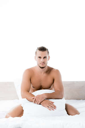 sexy shirtless man lying in bed isolated on whiteの写真素材