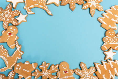 top view of winter gingerbread cookies on blue backgroundの写真素材