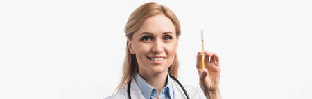happy nurse in white coat holding syringe with vaccine isolated on white, bannerの写真素材