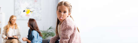 daughter fooling around while mother talking to psychologist, bannerの写真素材