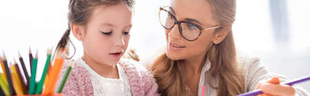 little girl with colorful pencils visiting psychologist, banner