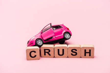 toy car and word crush on cubes on pink backgroundの写真素材