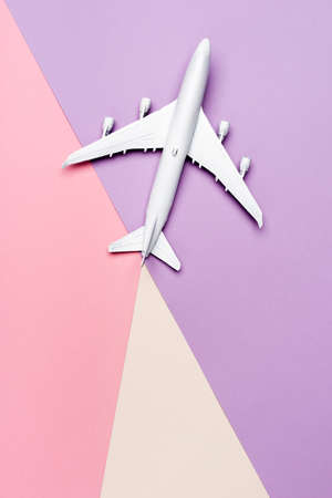 top view of white plane model on colorful background