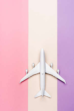 top view of white plane model on colorful background