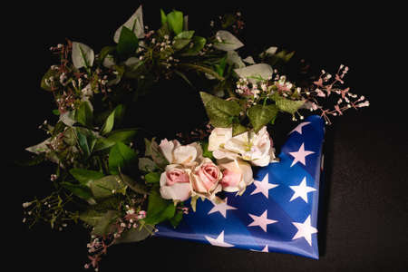 rose wreath and american flag on black background, funeral conceptの写真素材