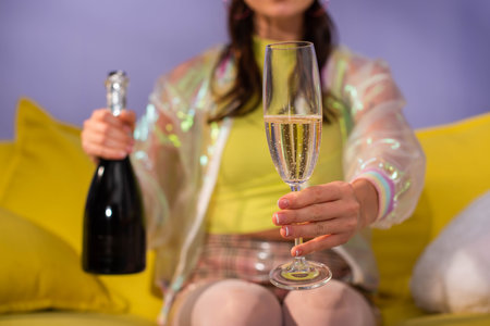 cropped view of young woman posing as doll with champagne