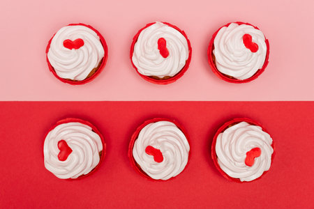 top view of valentines cupcakes on pink and red background