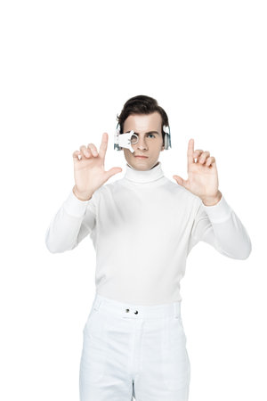 Brunette cyborg in digital eye lens and headphones using something isolated on whiteの写真素材