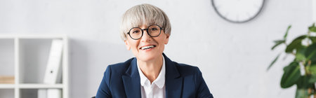 cheerful team leader in glasses smiling in office, banner