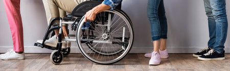 Cropped view of people standing near man in wheelchair in queue, banner