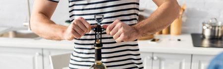 partial view of man opening bottle of wine, bannerの写真素材