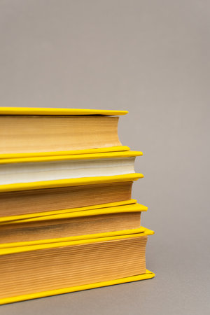 stack of yellow notebooks isolated on grayの写真素材