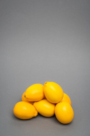 fresh and yellow lemons on gray backgroundの写真素材