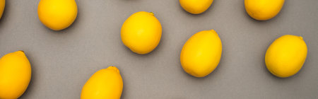 high angle view of fresh and yellow lemons on gray background, bannerの写真素材