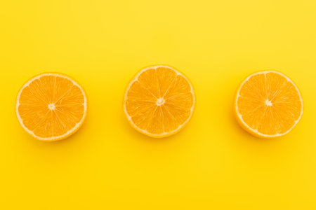 top view of juicy lemons halves isolated on yellow