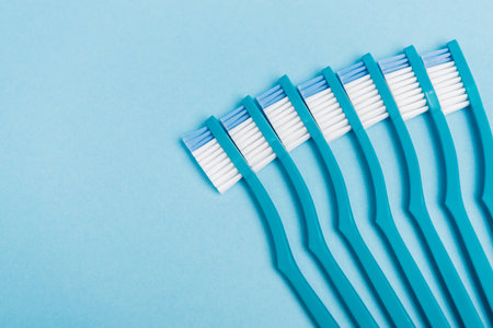 Top view of clean toothbrushes on blue backgroundの写真素材