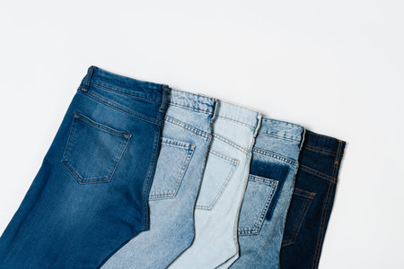 flat lay of different blue jeans on white background, top viewの写真素材