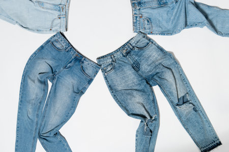 top view of various denim jeans on white backgroundの写真素材