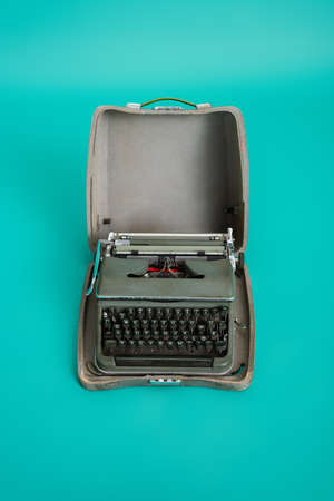 top view of vintage type machine in open case on turquoise backgroundの写真素材
