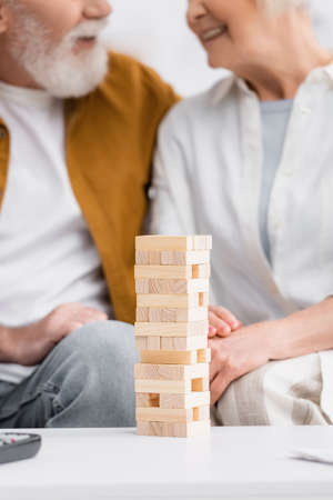 Cropped view of blocks wood tower game near senior couple on blurred backgroundの写真素材