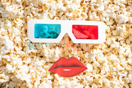 top view of 3d glasses near paper cut lips on tasty popcorn, cinema conceptの写真素材