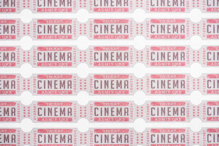 background from rows of cinema tickets on white, top viewの写真素材