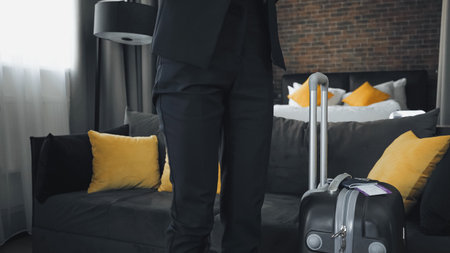 Businesswoman standing near cropped view of businesswomanの写真素材