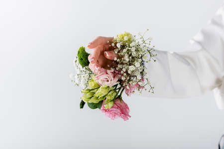 Cropped view of woman with different flowers in sleeve of blazer isolated on grayの写真素材
