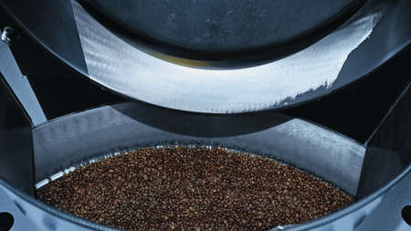 high angle view of roasted coffee beans in modern roasting machineの写真素材