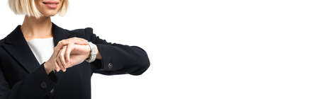 cropped view of smiling businesswoman checking time on wristwatch isolated on white, bannerの写真素材