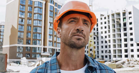 Handsome builder looking away on construction site