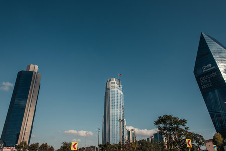 ISTANBUL, TURKEY - NOVEMBER 12, 2020: modern skyscrapers and green trees against blue skyのeditorial素材