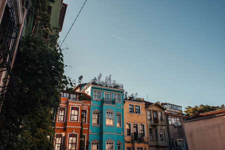 blue, cloudless sky above colorful houses with green ivy in Balat, Istanbul, Turkeyの写真素材