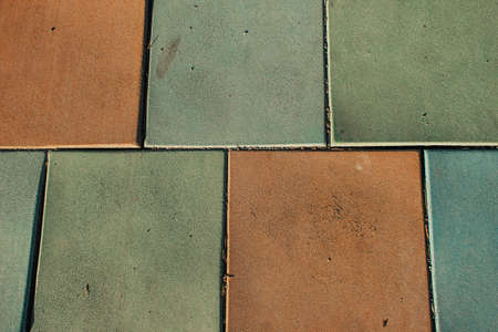 background with brown and gray ceramic tiles, top view