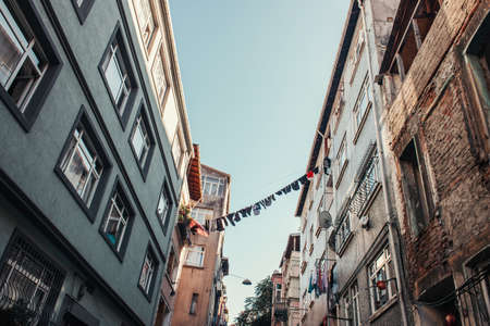 clothesline with laundry between modern and old buildings in Balat quarter, Istanbul, Turkeyの写真素材