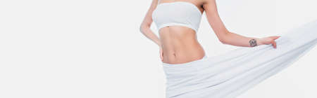 Cropped view of woman in bra holding cloth isolated on white, bannerの写真素材