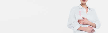 Cropped view of woman with ribbon of breast cancer awareness isolated on white, bannerの写真素材