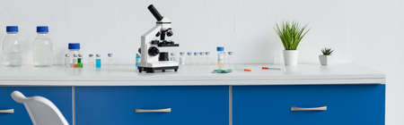 Vaccines, pills and microscope on table in laboratory, bannerの写真素材