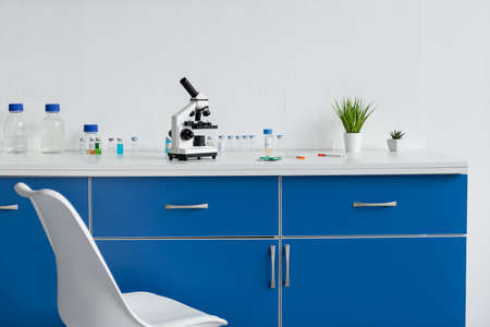 Microscope and vaccines on table in laboratoryの写真素材