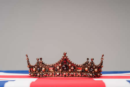 golden royal crown on british flag isolated on grayの写真素材