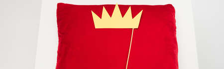 top view of paper crown on stick and red velvet pillow on gray, bannerの写真素材