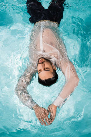 Top view of muslim manager swimming in pool