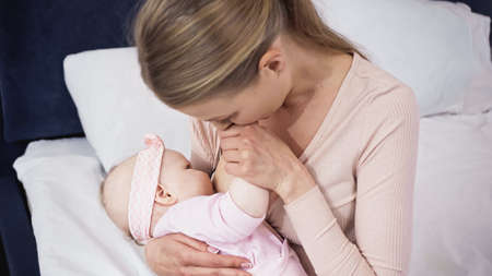 overhead view of mother breastfeeding baby at home