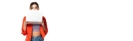 young woman covering face with laptop isolated on white, bannerの写真素材